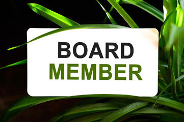 Board Member text on white surrounded by green leaves