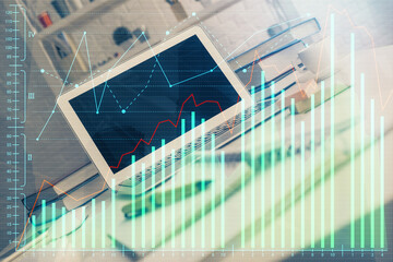 Financial graph colorful drawing and table with computer on background. Double exposure. Concept of international markets.