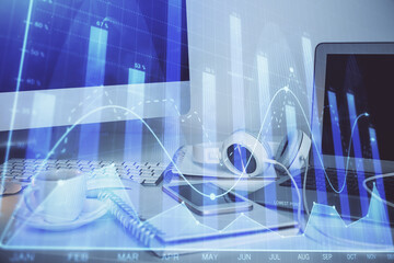 Stock market graph and table with computer background. Multi exposure. Concept of financial analysis.