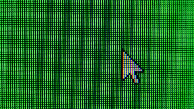The cursor arrow moves across the green screen and highlights an area. Screen monitor pixels close up.