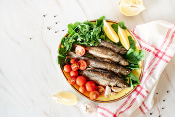 Plate with baked fish and fresh vegetables top view flat lay