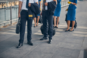 Fototapeta premium Pilots and flight attendants standing on the street