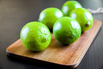 Organic fresh limes on a cutting board