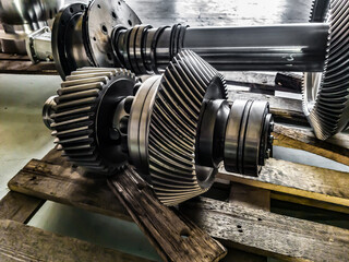 Disassembled gearbox after repair on a wooden rack in a workshop.