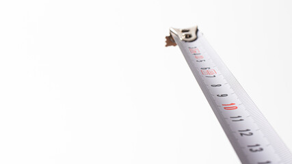 A centimetre roulette tape on a white background with a place for copyspace text. Banner for the construction store, measuring length