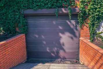 Modern, automatic up and over garage door. Close- up photo with selective focuse.