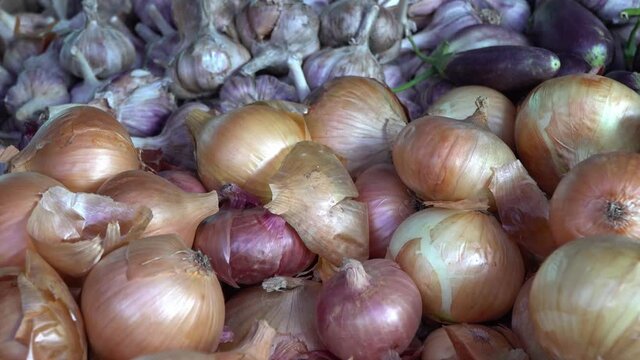  Onion and garlic on the counter of the farmers market close-up