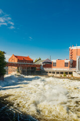 Kouvola, Finland - 15 September 2020: Old red brick buildings of Upm factory on rapids Kuusankoski.