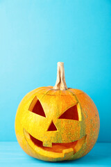 Halloween pumpkin head jack lantern on blue background. Vertical foto