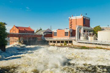 Kouvola, Finland - 15 September 2020: Old red brick buildings of Upm factory on rapids Kuusankoski.