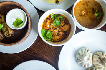 Food concept. Soup, chicken, salat on wooden table