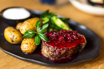 Grilled potatoes and steak with cucumbers