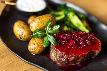 Grilled potatoes and steak with cucumbers