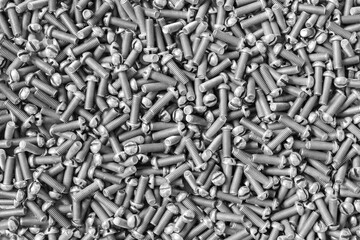 Stack of metal bolts for background. Concept of construction and repair. Black and white.