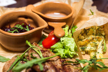 Grilled meat with green, vegetables and sauce