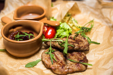 Grilled meat with green, vegetables and sauce