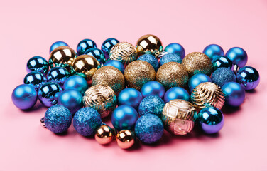 Christmas composition. Gold blue decorations on pastel pink background. Christmas, winter, new year concept. Flat lay, top view, copy space.