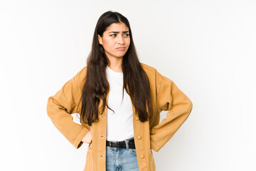 Young indian woman isolated on purple background confused, feels doubtful and unsure.