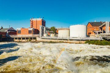 Kouvola, Finland - 15 September 2020: Old red brick buildings of Upm factory on rapids Kuusankoski...