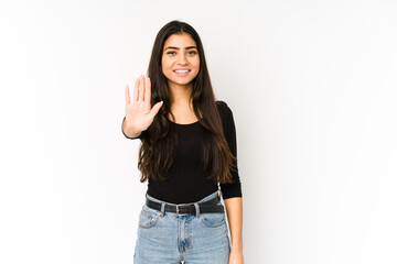 Young indian woman isolated on purple background smiling cheerful showing number five with fingers.
