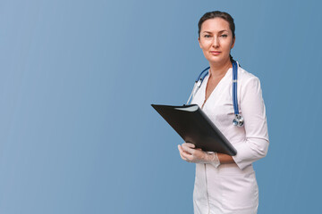 Adult female doctor in uniform with a folder looking at the camera. Isolated on blue background