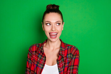 Close-up portrait of her she nice attractive pretty lovely cheery dreamy girl in checked shirt licking lip fantasizing overthinking isolated on bright vivid shine vibrant green color background