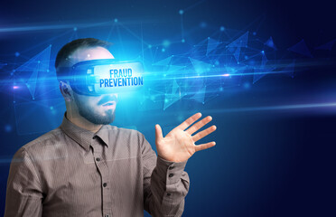 Businessman looking through Virtual Reality glasses with FRAUD PREVENTION inscription, cyber security concept