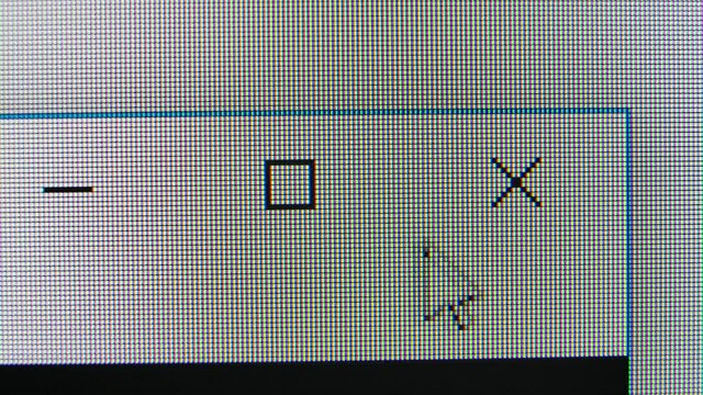 Macro shot of the computer screen on which the cursor moves. Click on the close button. Super macro pixels.