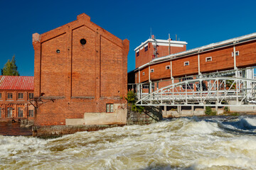 Kouvola, Finland - 15 September 2020: Old red brick buildings of Upm factory on rapids Kuusankoski.