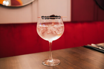 Classic cocktail glass on wooden table in restaurant