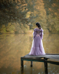 Lake Story: a woman in pink stands on a bridge by a pond