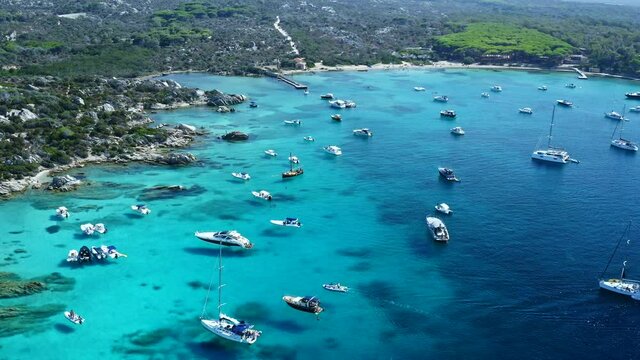 Flying Down over Boats and Luxury Yachts at Caprera Island Bay in Sardinia. Caribbean Water. Cala Serena. Famous Travel Destination. Sardegna, Italy.