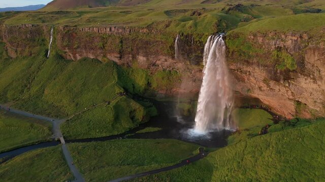 Seljalandsfoss, South Iceland. Water originated from glacier Eyjafjallajökull makes this majestic waterfall. Areal shot just before sunset, beautiful soft yellow light in Iceland Midnight Sun.