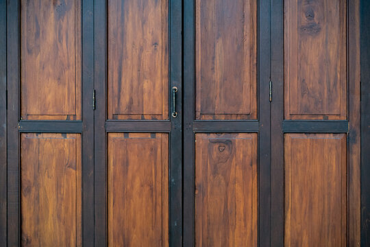 Black and brown old wooden folding doors.