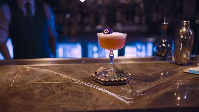 Stock video of an expert barman making a cocktail at night club.