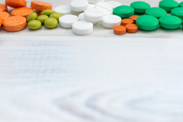 Medical flatlay with mask and tablets on a white wooden background. Medical concept. Top view.