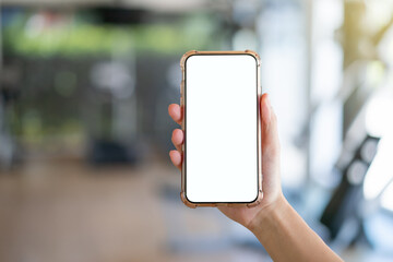 Woman hand holding mobile phone with blank white screen mockup.