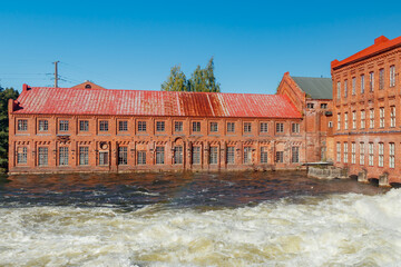 Kouvola, Finland - 15 September 2020: Old red brick buildings of Upm factory on rapids Kuusankoski.