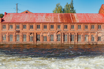 Kouvola, Finland - 15 September 2020: Old red brick buildings of Upm factory on rapids Kuusankoski.
