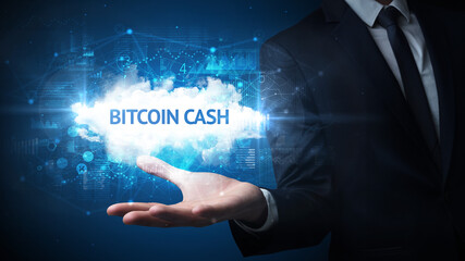 Hand of Businessman holding BITCOIN CASH inscription, successful business concept