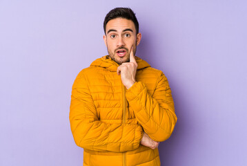 Fototapeta premium Young caucasian man isolated on purple background having some great idea, concept of creativity.