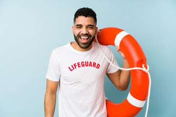 Young latin lifeguard man isolated laughing and having fun.