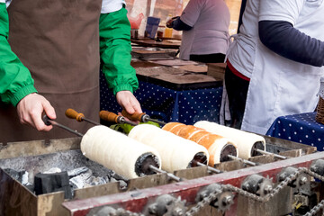 Sweet hungarian and Czech dessert - baked kurtosh kalach (Kurtoskalacs) or trdlo on the holiday market in Serbia