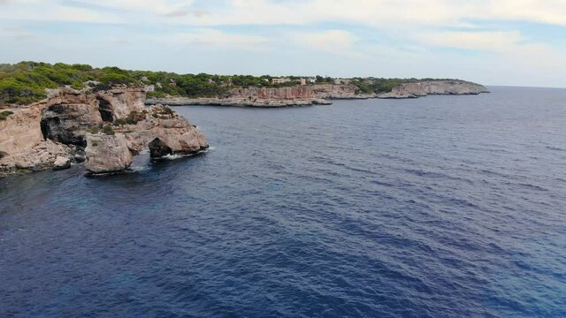 The beautiful drone shot of the coast and blue sea in Mallorca.