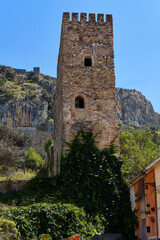 Fototapeta na wymiar Famous historic buildings castle tower view against blue sky located on hill above the town of Xativa, Valencia, Spain