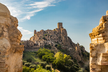 Fototapeta na wymiar Craco, Matera, Basilicata, Italy. The ghost town destroyed and abandoned following a landslide. View of the remains and ruins of the ancient village built on the top of the hill. Watchtower at the top