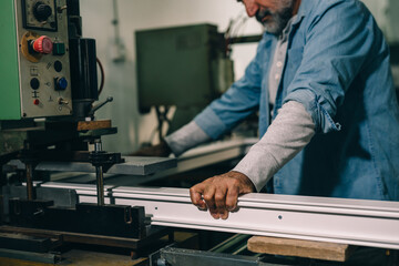 Aluminium and PVC industry worker making PVC or aluminium frames for windows and doors