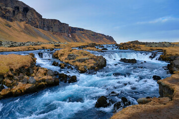 Wild river with mountains in the background.