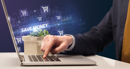 Fototapeta na wymiar Businessman working on laptop with SAVE MONEY inscription, online shopping concept