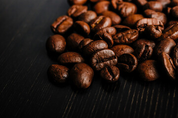 Coffee beans on wooden background.